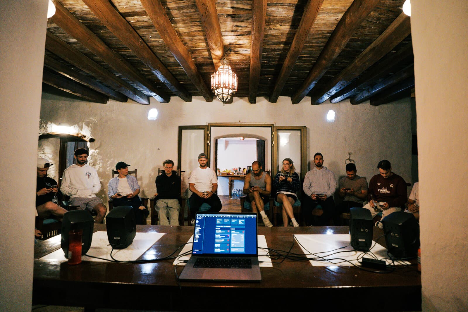 Collaborators gathered around a writing session in Ibiza