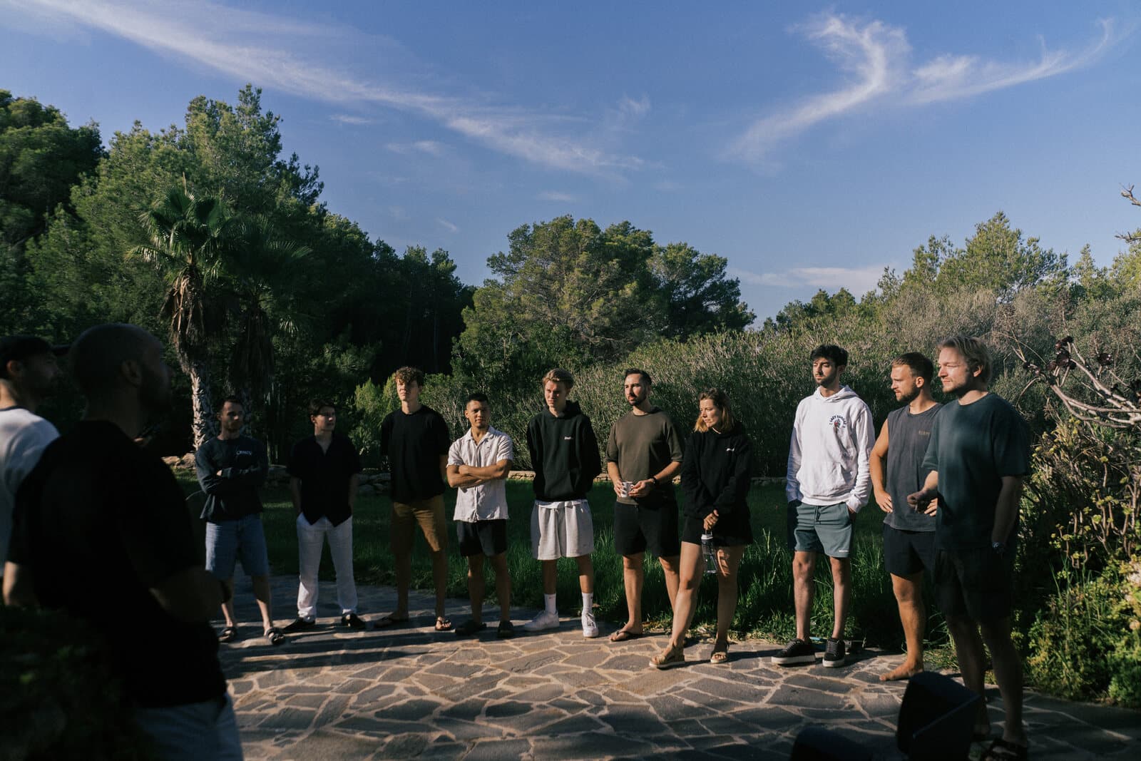 A group of writers gathered outdoors at an Ibiza camp