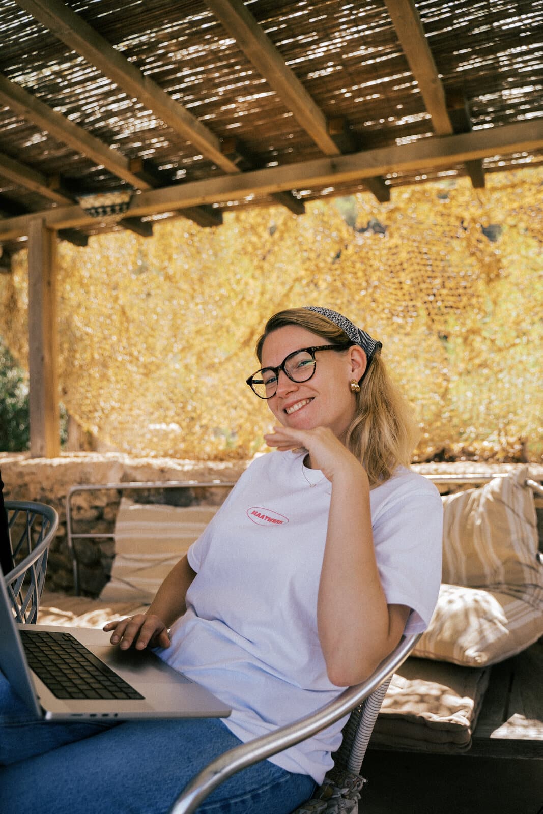 Collaborators writing together in a sunlit Spanish setting